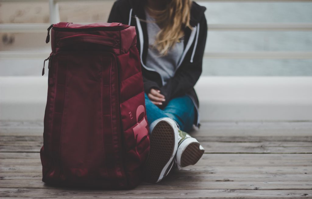 homeless student sitting on ground